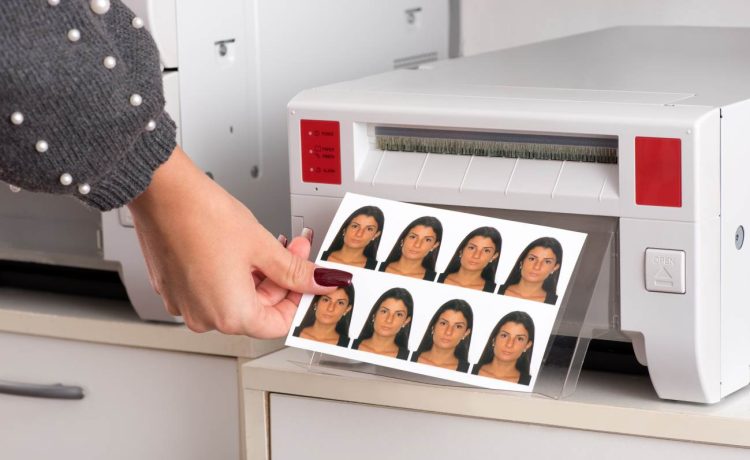 Just printed passport photos exiting a printer